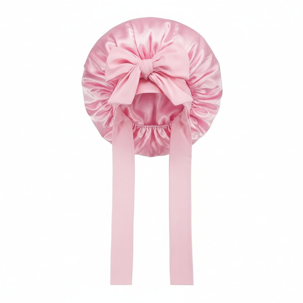 pink satin bonnet with a matching headband on a white background