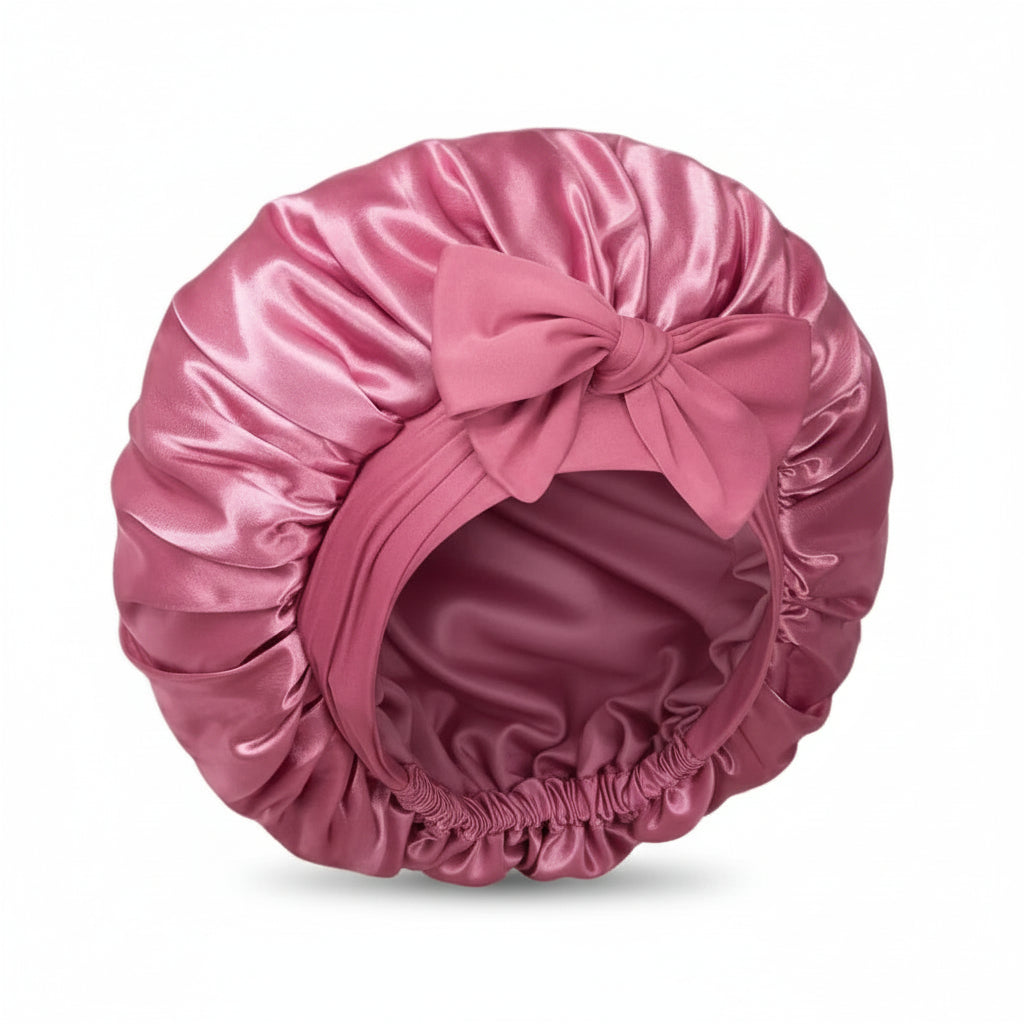pink satin bonnet on a white background